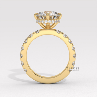 Front view of a round cut moissanite engagement ring with a hidden halo and pave band from the right