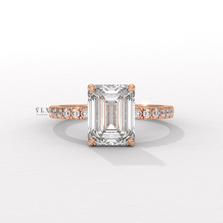 Side profile of a emerald cut moissanite engagement ring with a hidden halo and pave band
