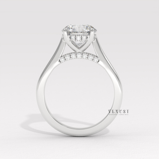 Close-up of a round brilliant moissanite engagement ring with a hidden halo and cathedral setting