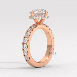 Profile shot of a round cut moissanite engagement ring with a hidden halo and pave band and its band