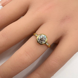 round cut moissanite engagement ring bezel hand view
