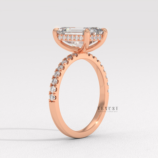 Full view of a emerald cut moissanite engagement ring with a hidden halo and pave band with band detail