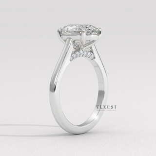 Front view of a oval cut moissanite engagement ring in a hidden halo solitaire setting under bright light