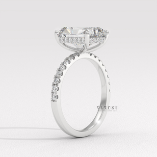 Front view of a radiant cut moissanite engagement ring with a hidden halo and pave band from the left