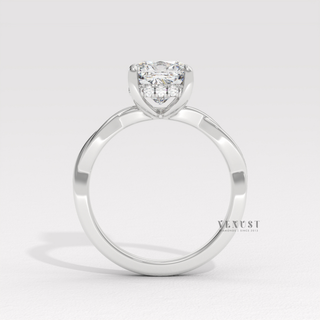 Three-quarter angle of a cushion cut moissanite engagement ring on an infinity band