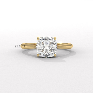 Tilted view of a cushion cut moissanite engagement ring with a hidden halo and cathedral setting showing its sparkle