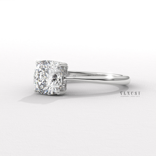 Low-angle view of a cushion cut moissanite engagement ring with a hidden halo and cathedral setting