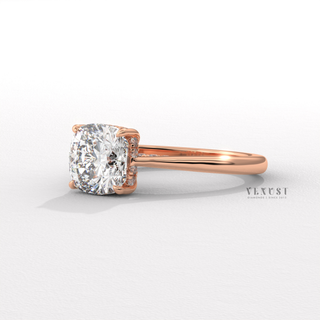 Centre-stone close-up of a cushion cut moissanite engagement ring with a hidden halo and cathedral setting