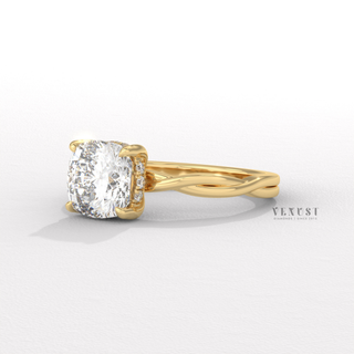 Low-angle view of a cushion cut moissanite engagement ring on an infinity band