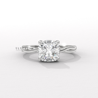 Centre-stone close-up of a cushion cut moissanite engagement ring on an infinity band