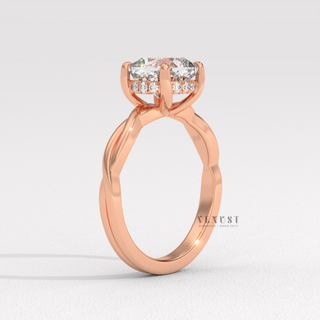 Front view of a cushion cut moissanite engagement ring on an infinity band