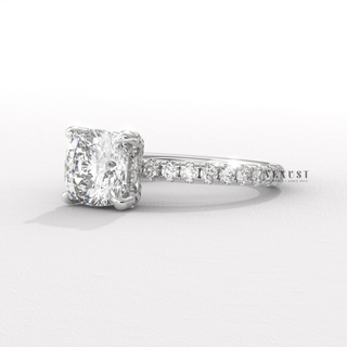 Full view of a cushion cut moissanite engagement ring with a pave band with band detail