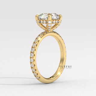 Close-up of a cushion cut moissanite engagement ring with a pave band