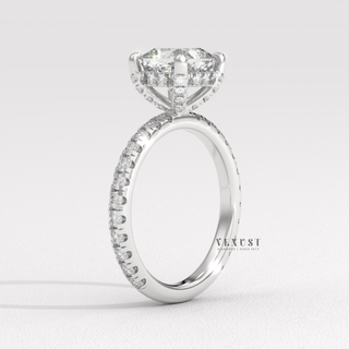 Macro shot of the centre stone on a cushion cut moissanite engagement ring with a pave band