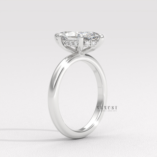 Front view of a marquise cut moissanite engagement ring in a hidden halo solitaire setting from the left