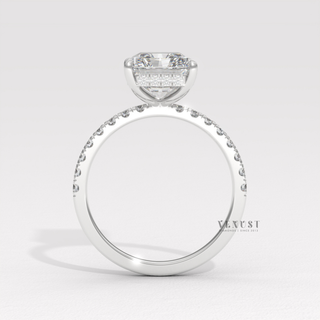 Front view of a radiant cut moissanite engagement ring with a hidden halo and pave band under bright light