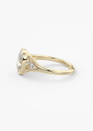 Elongated cushion three stone bezel engagement ring side detail view