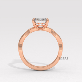 Three-quarter angle of a emerald cut moissanite engagement ring on an infinity band