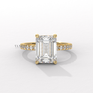 Detailed setting shot of a emerald cut moissanite engagement ring with a hidden halo and pave band