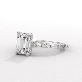 Profile shot of a emerald cut moissanite engagement ring with a pave band and its band