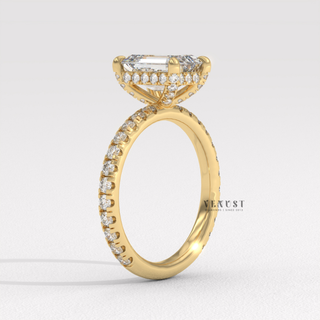 Full view of a emerald cut moissanite engagement ring with a pave band with band detail