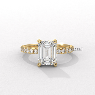 Hand model wearing a emerald cut moissanite engagement ring with a pave band