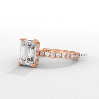 Lifestyle photo of a emerald cut moissanite engagement ring with a pave band on the hand