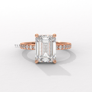 Hand model wearing a emerald cut moissanite engagement ring with a hidden halo and pave band