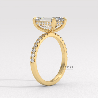 Profile shot of a emerald cut moissanite engagement ring with a hidden halo and pave band and its band