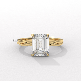 Studio shot of a emerald cut moissanite engagement ring on an infinity band on a plain backdrop