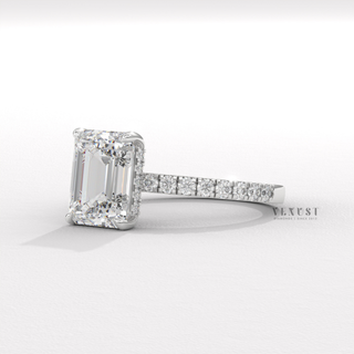 Macro shot of the centre stone on a emerald cut moissanite engagement ring with a hidden halo and pave band