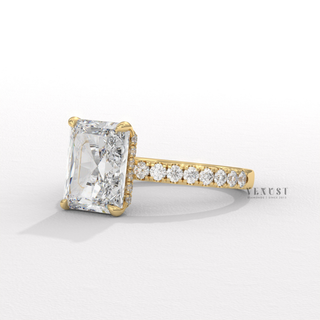 Close-up of a radiant cut moissanite engagement ring with a pave band