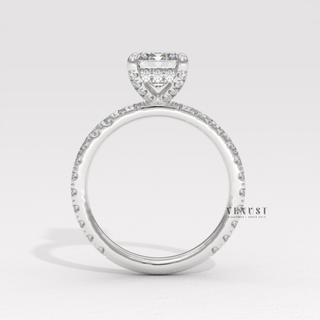 Overhead close-up of a emerald cut moissanite engagement ring with a pave band