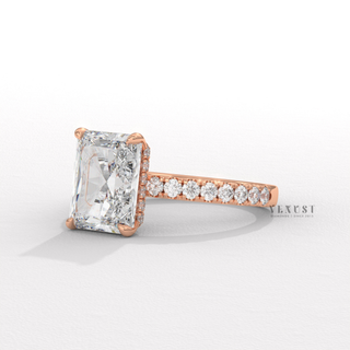 Three-quarter angle of a radiant cut moissanite engagement ring with a pave band
