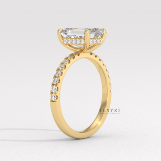 Emerald cut moissanite engagement ring with a hidden halo and pave band worn on a hand