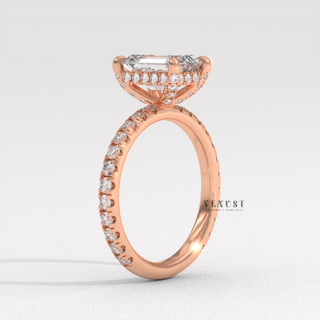 Front view of a emerald cut moissanite engagement ring with a pave band