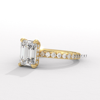 Low-angle view of a emerald cut moissanite engagement ring with a pave band