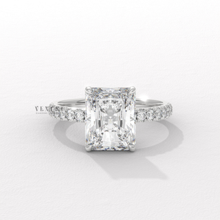 Top-down view of a radiant cut moissanite engagement ring with a pave band