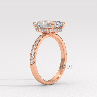 Radiant cut moissanite engagement ring with a pave band photographed on a white background