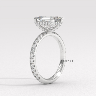Side profile of a emerald cut moissanite engagement ring with a pave band