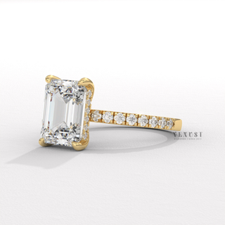 Centre-stone close-up of a emerald cut moissanite engagement ring with a hidden halo and pave band