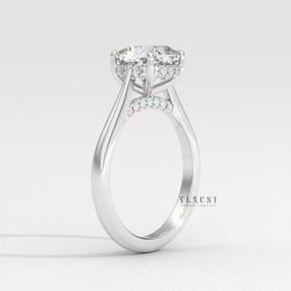 Full view of a cushion cut moissanite engagement ring with a hidden halo and cathedral setting with band detail