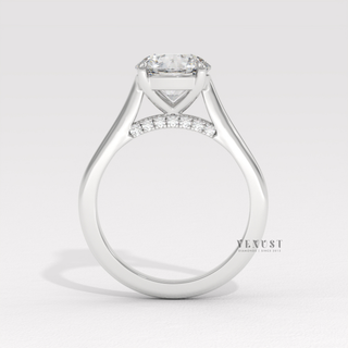 Front view of a round cut moissanite engagement ring with a hidden halo and cathedral setting