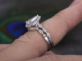 Stunning 1.0ct pear halo moissanite ring shown on a finger