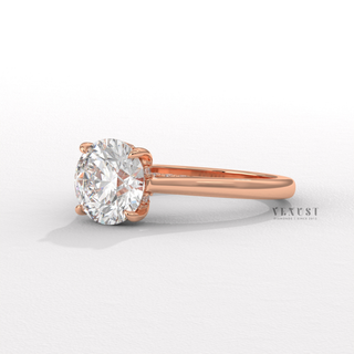 Low-angle view of a round brilliant moissanite engagement ring with a hidden halo and cathedral setting