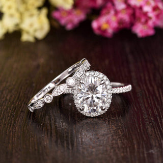 Luminous 1.50ct oval halo moissanite ring shown on a finger image 2