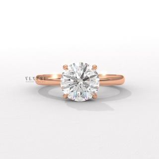 Macro shot of the centre stone on a round cut moissanite engagement ring in a solitaire setting