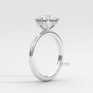 Detailed setting shot of a round cut moissanite engagement ring in a solitaire setting