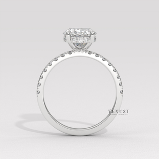 Front view of a oval cut moissanite engagement ring with a hidden halo and half pave band under bright light