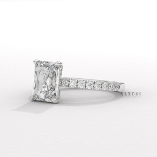 Hand model wearing a radiant cut moissanite engagement ring with a hidden halo and pave band